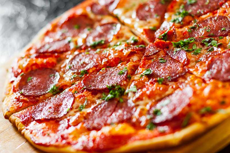 sliced Pepperoni Pizza with Mozzarella cheese, salami, Tomatoes,